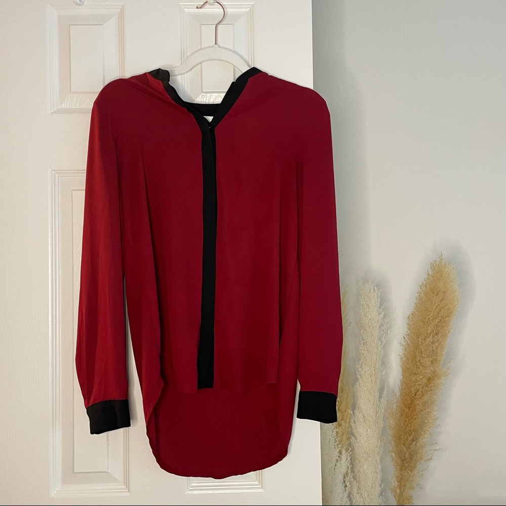 Maroon button down blouse with black trim details